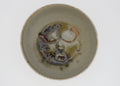 Ceramic bowl with abstract face design on a white background