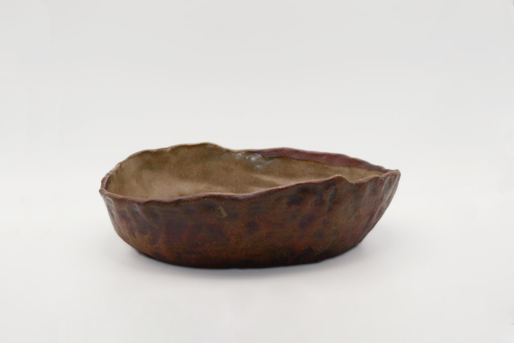 Brown ceramic bowl on a white background