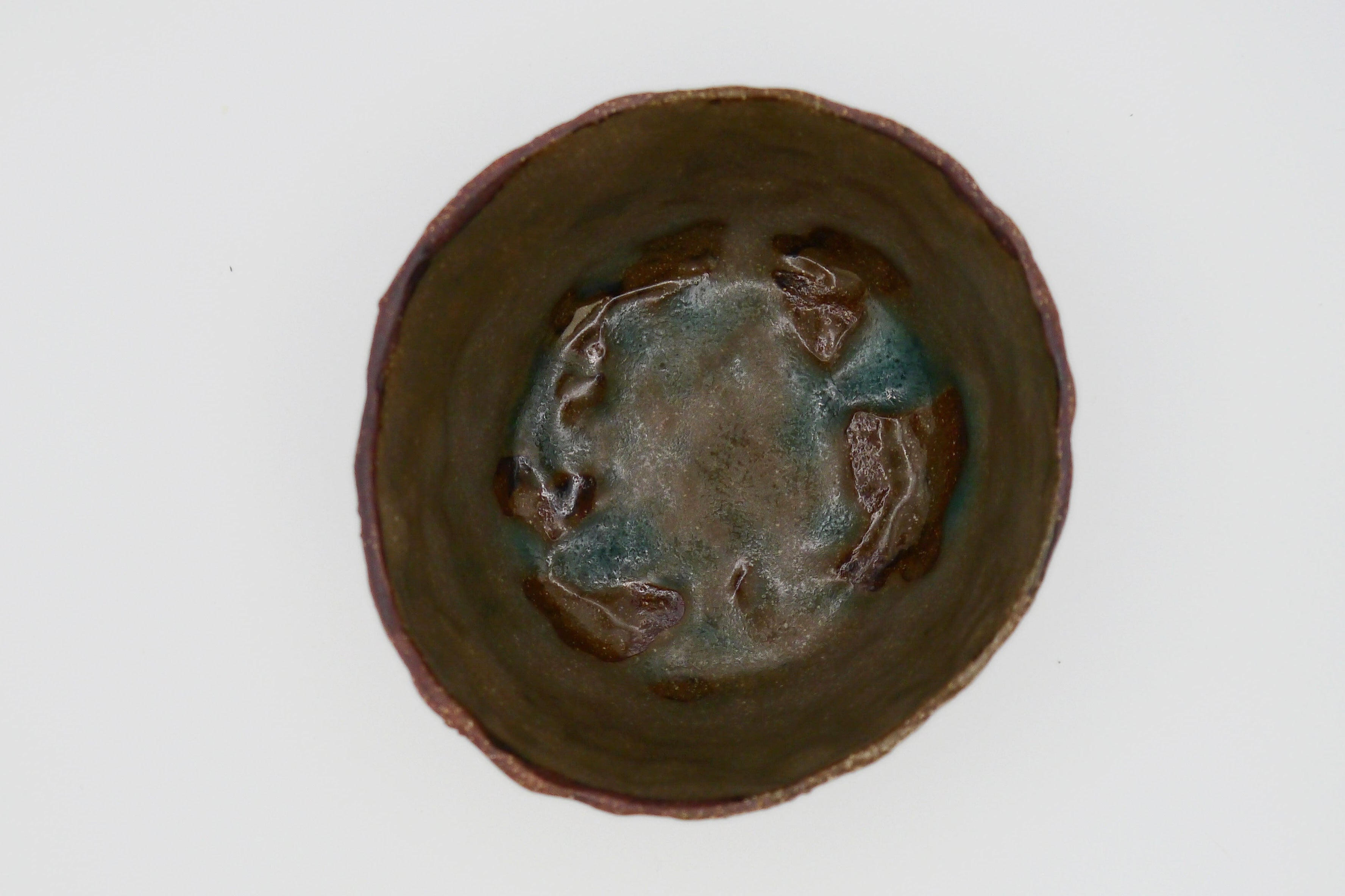 Ceramic bowl with a textured surface on a white background